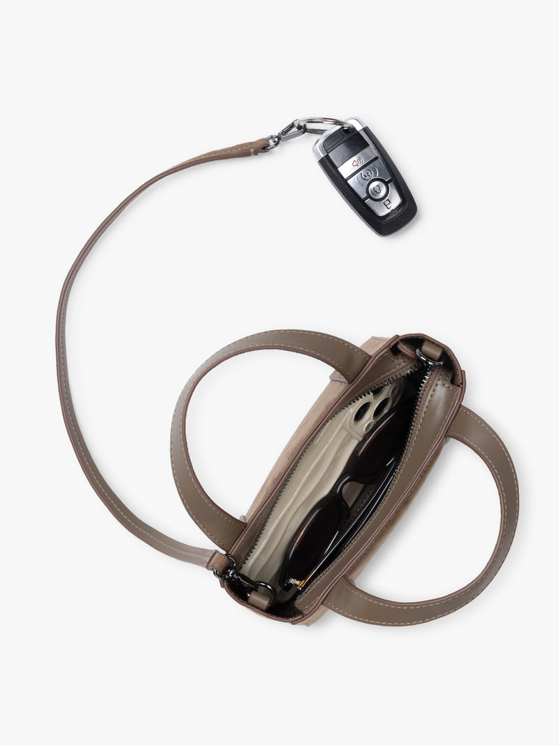 Top view and key line of CALPAK Haven Mini Crossbody Bag in brown Truffle Suede with top handles on a plain white background