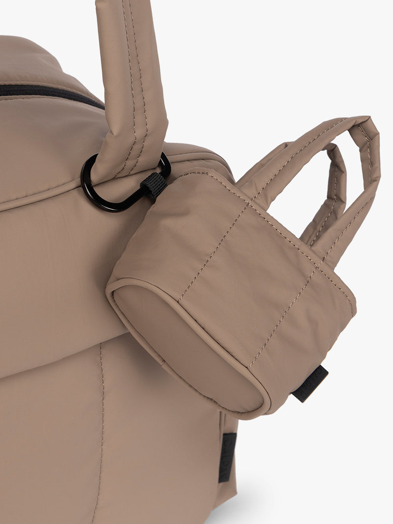 CALPAK Luka Tote Zip Bag Charm in light brown Chocolate with carabiner attached on a bag