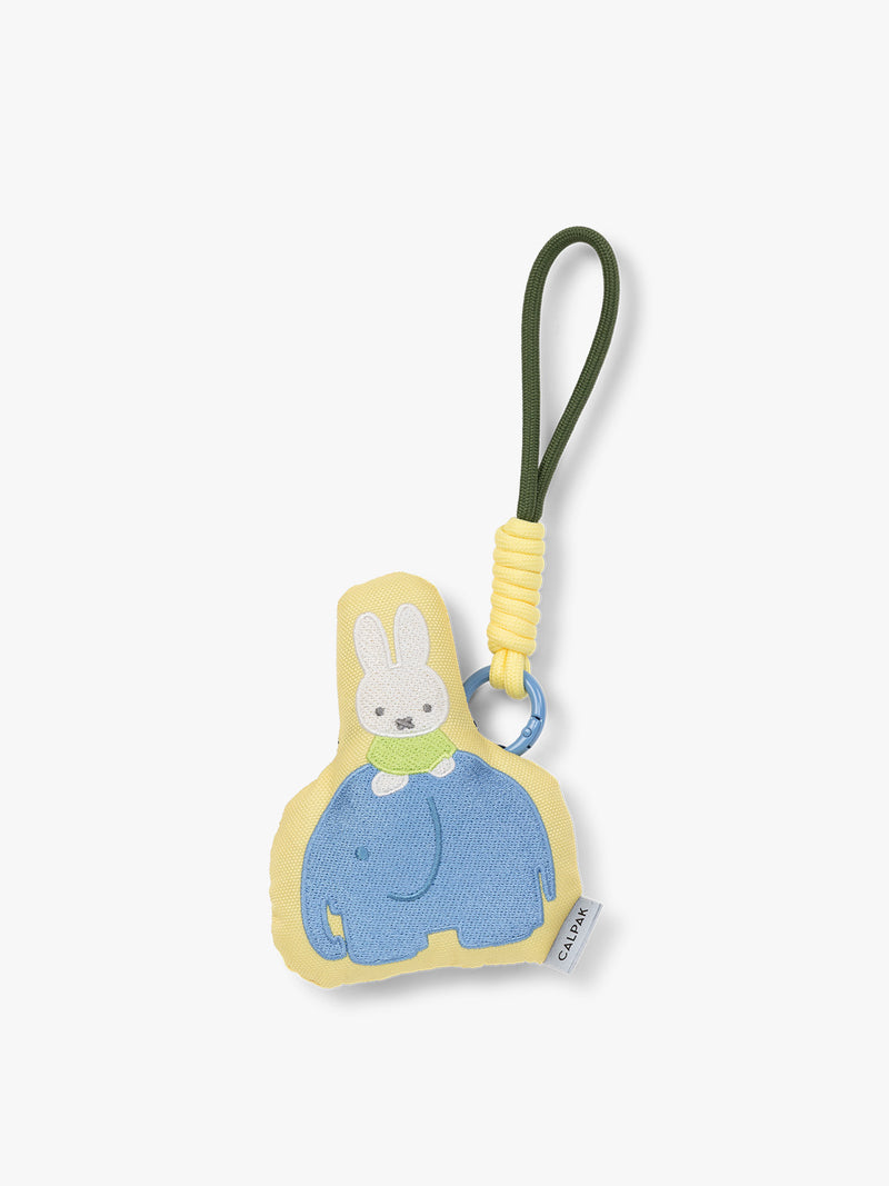 Plush Miffy x CALPAK Pluffy Bag Charm keychain with a yellow border and Miffy on a blue elephant on a white background