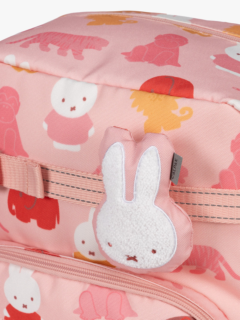 Colorful CALPAK + Miffy Kids Essentials Set with children's Medium backpack, lunch bag , pencil case set on a white background with pink accents and Miffy with other animals
