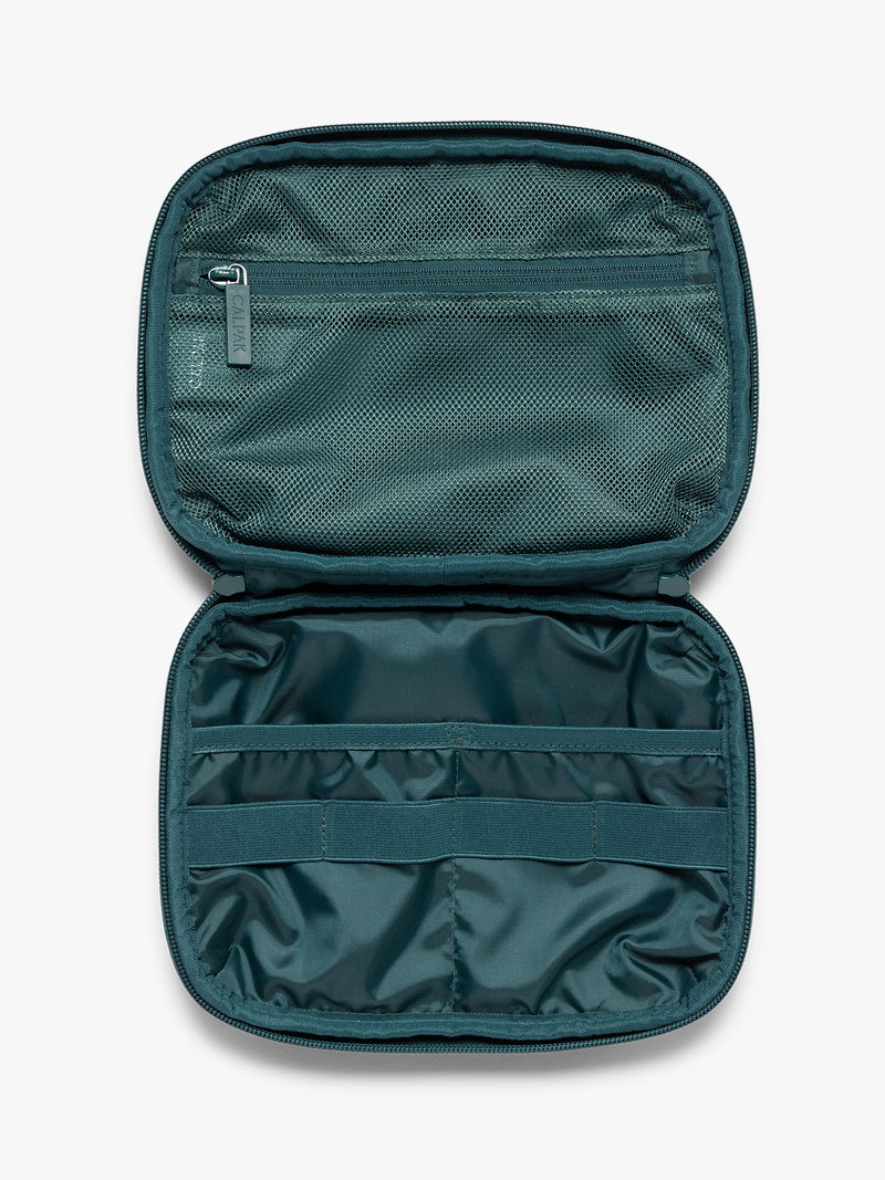 Opened dark teal green CALPAK Tech Organizer pouch with a front zippered pocket and top zipper, shown against a plain white background