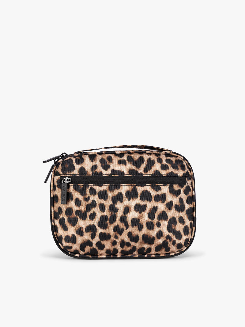 Backside of a small rectangular CALPAK Tech Organizer pouch in Leopard with a leopard print pattern in beige, brown, and black, featuring a black horizontal zipper across the front