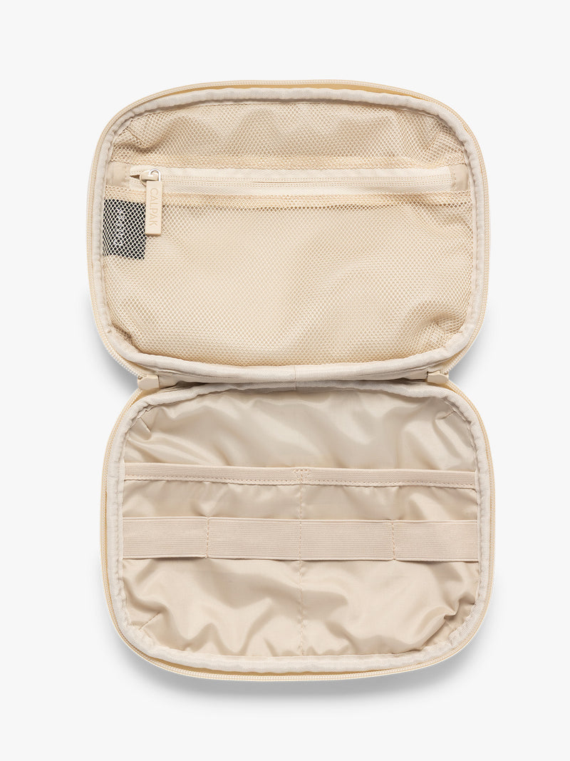Opened rectangular CALPAK Tech Organizer pouch in Snow Leopard with a black and beige animal print Leopard pattern, featuring a cream-colored zipper and a small black brand tag on the right side