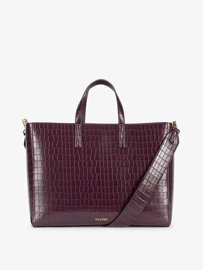 CALPAK Haven 16 Laptop Tote in Dark Cherry deep red crocodile-embossed tote bag with top handles and a detachable shoulder strap, shown against a plain white background; ATO2102-DARK-CHERRY-FAUX-CROC view 1