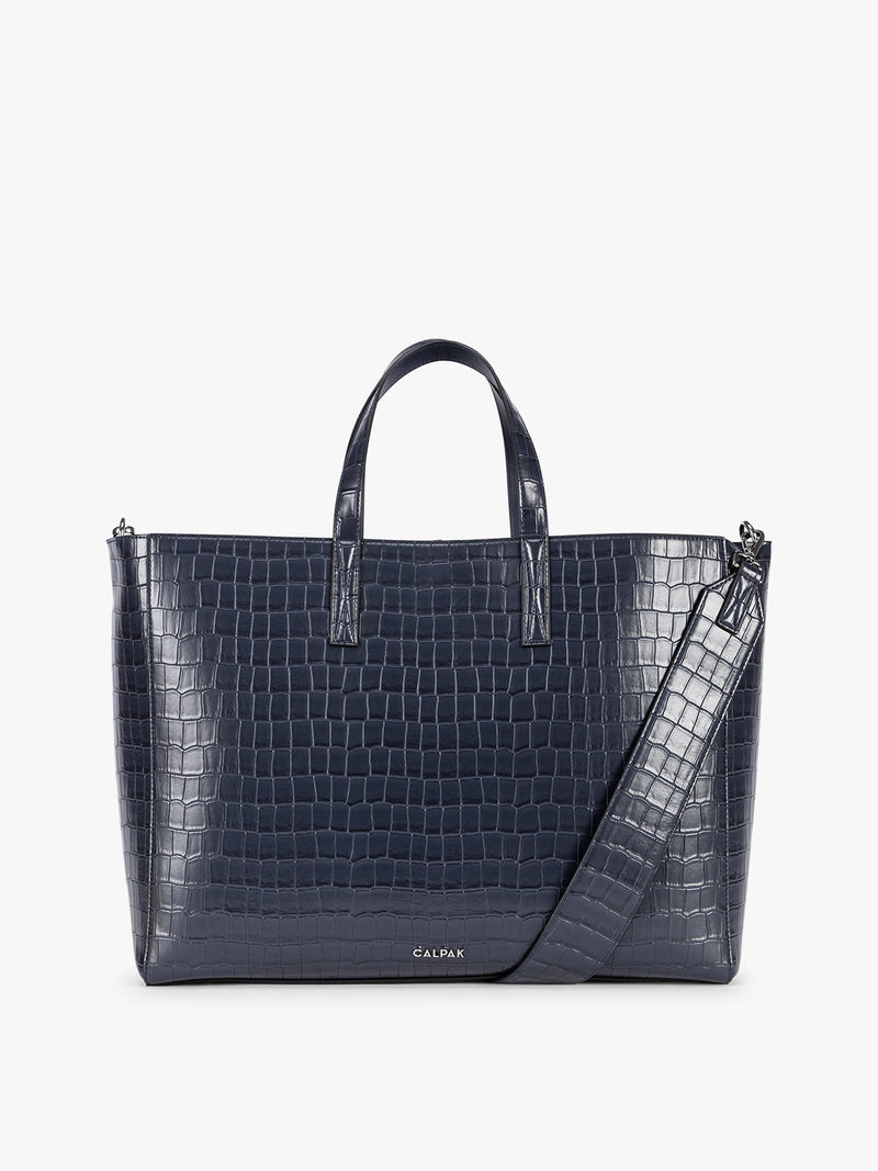 CALPAK Haven 16" Laptop Tote in blue Navy crocodile-embossed tote bag with top handles and a detachable shoulder strap, shown against a plain white background