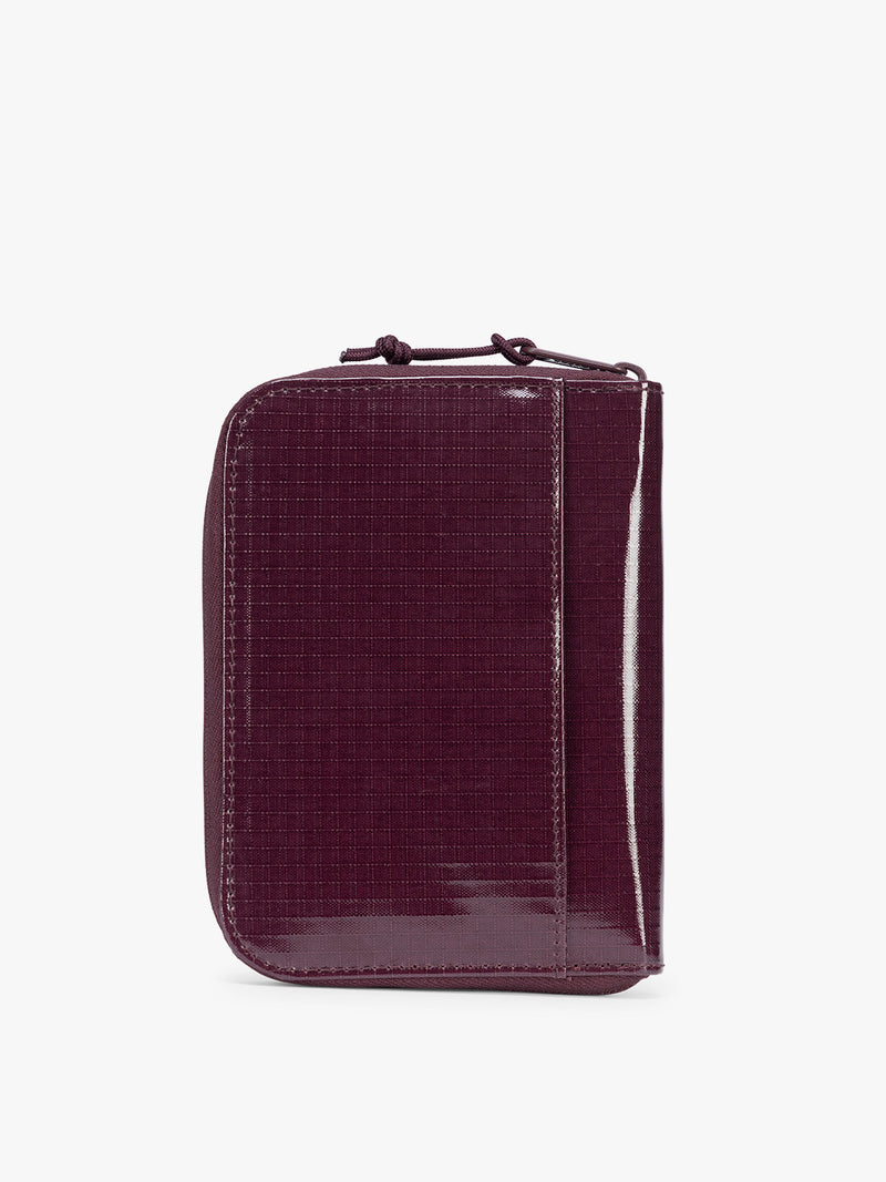 Back view of  CALPAK Terra Zip Passport Wallet in dark red Dark Cherry on a white background