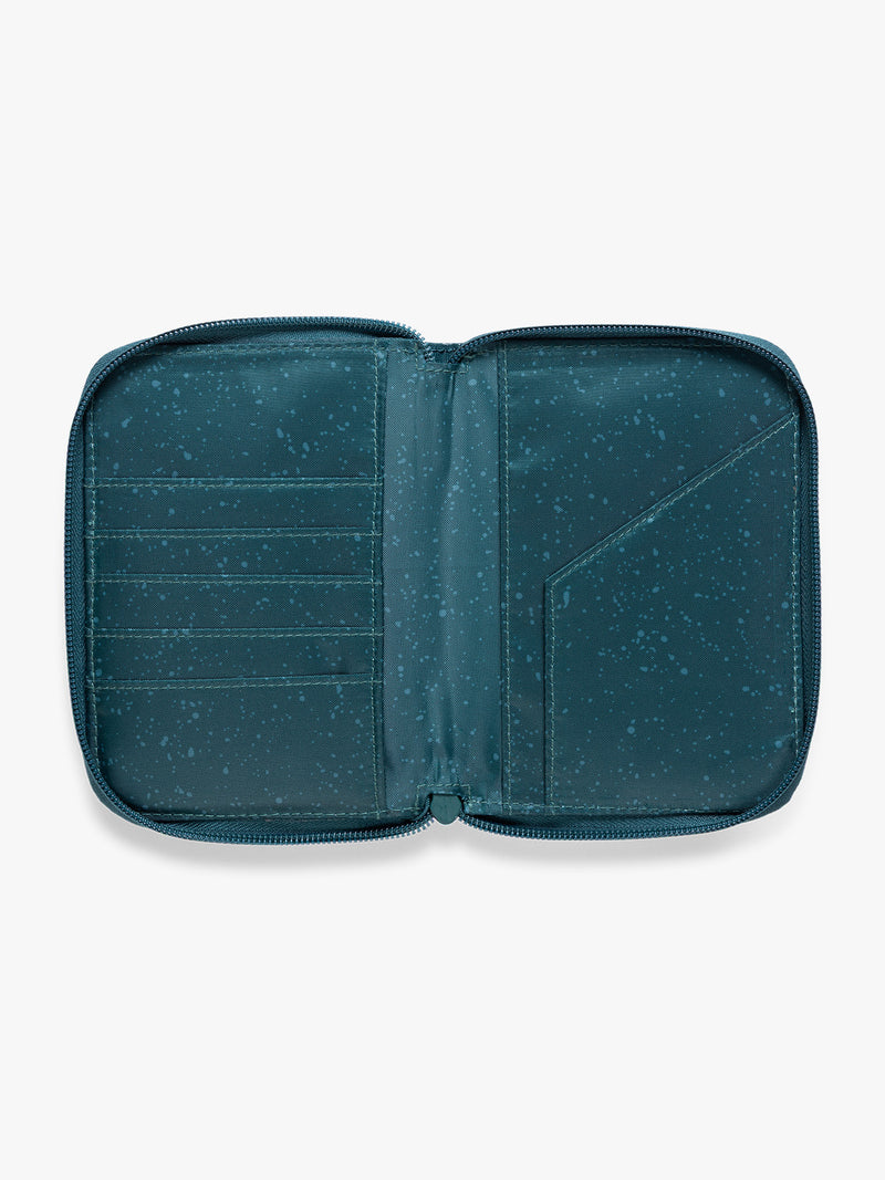 Opened view of  CALPAK Terra Zip Passport Wallet in blue green Kale on a white background