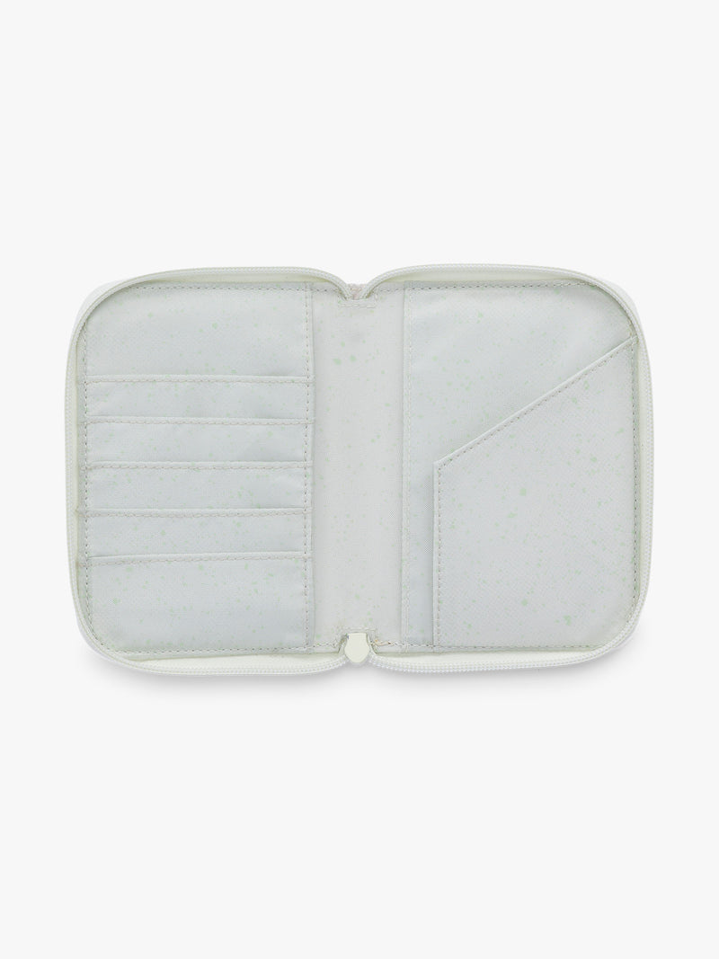 Opened Front side of CALPAK Terra Zip Passport Wallet in shiny white Moonbeam