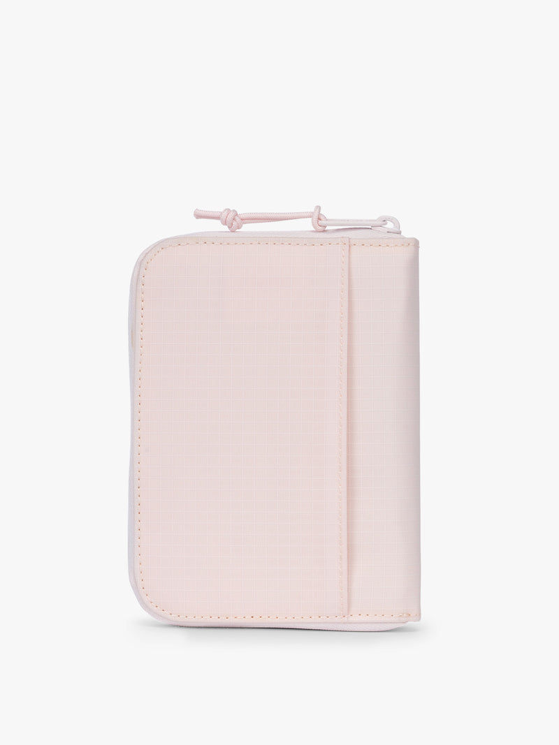 Backside of CALPAK Terra Zip Passport Wallet in light pink Shell Pink