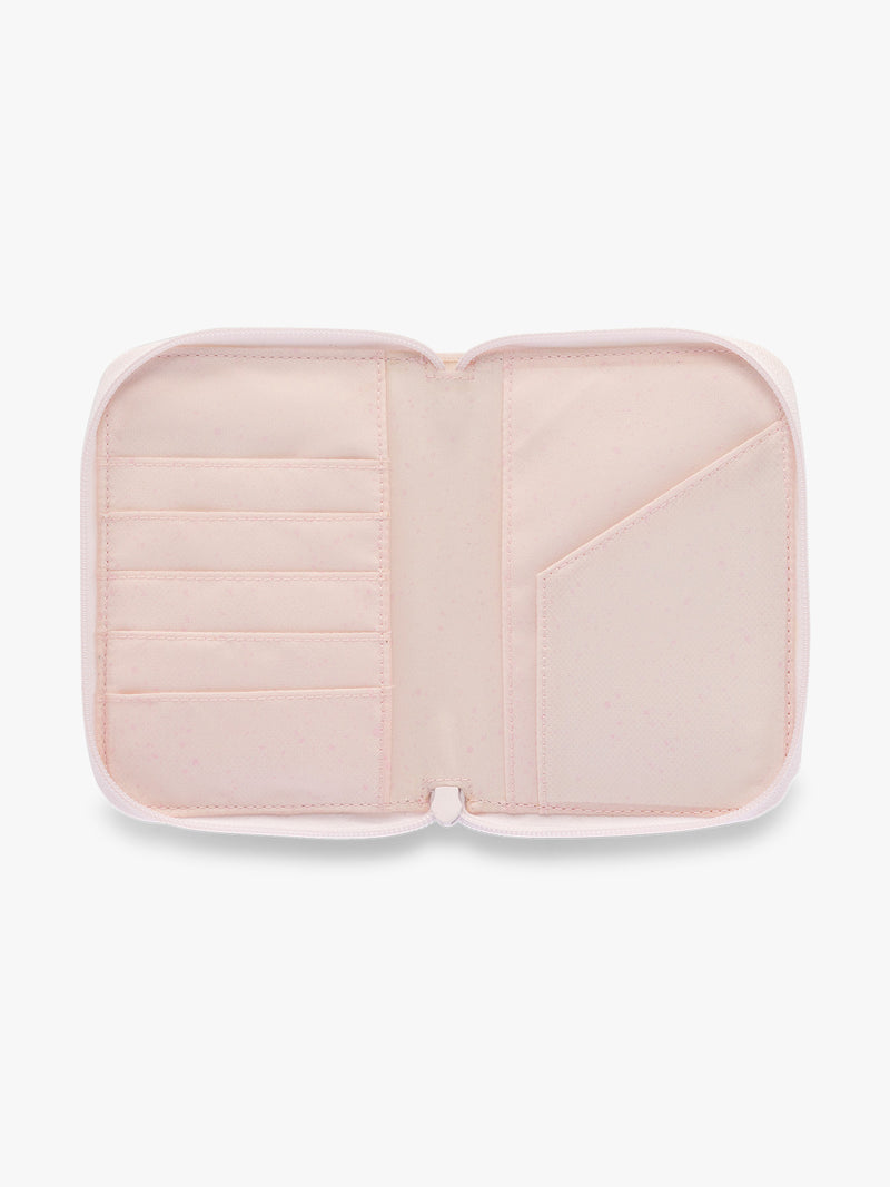 Opened CALPAK Terra Zip Passport Wallet in light pink Shell Pink