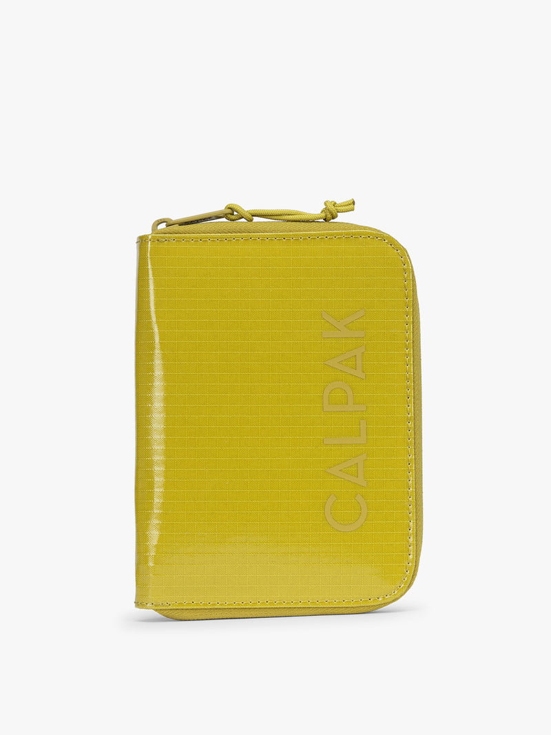 CALPAK Terra Zip Passport Wallet in yellow green Wasabi on a white background