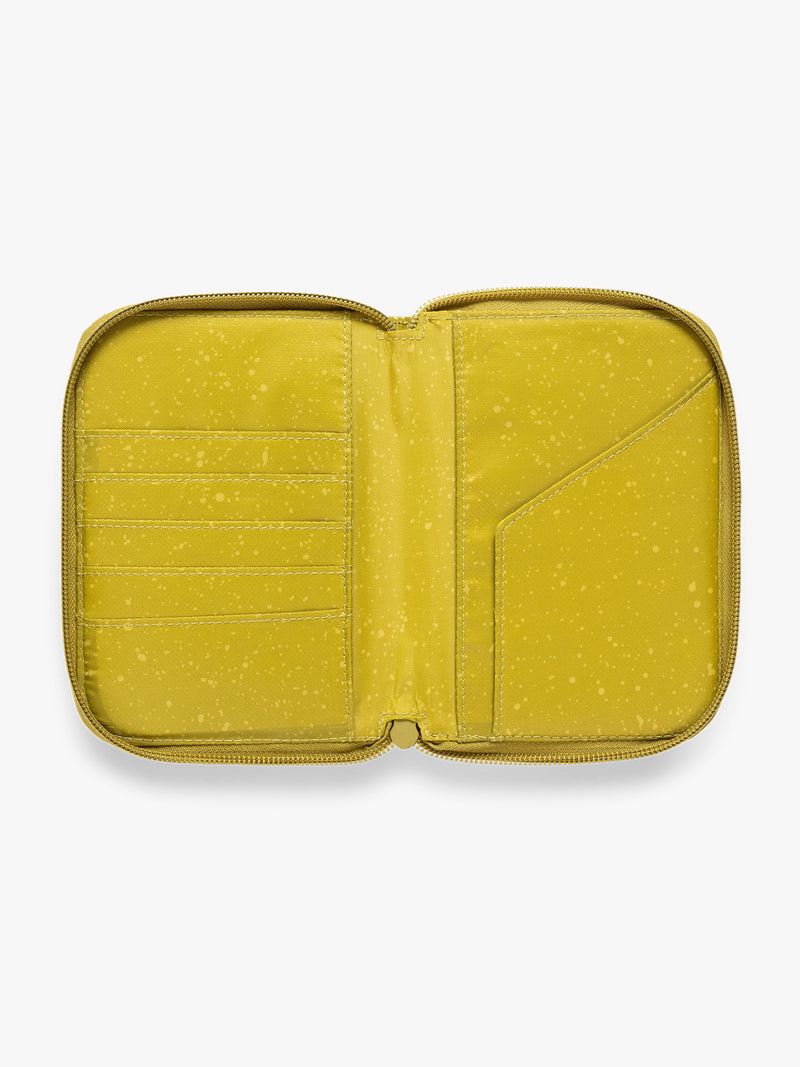 Opened view of  CALPAK Terra Zip Passport Wallet in yellow green Wasabi on a white background