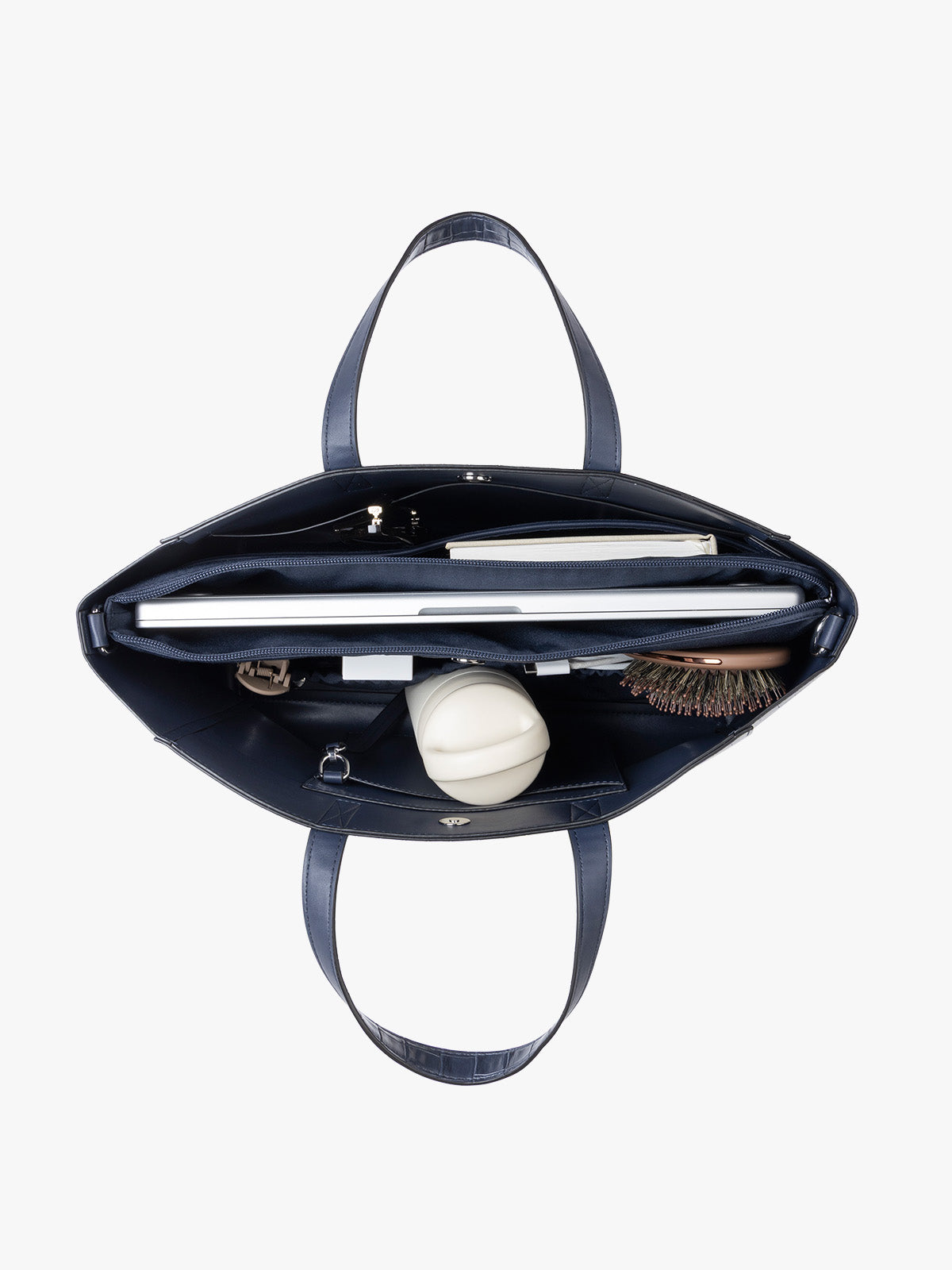 A navy CALPAK Haven 15" Laptop Tote in Navy blue crocodile-embossed with dual top handles and a matching shoulder strap against a plain white background with items inside; ATS2501-NAVY-FAUX-CROC