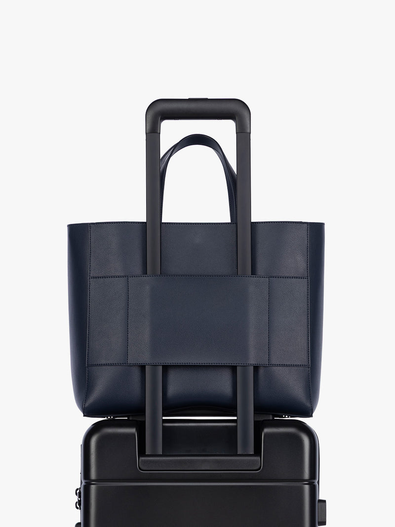 Trolley sleeve feature of CALPAK Haven 15" Laptop Tote in dark blue Navy