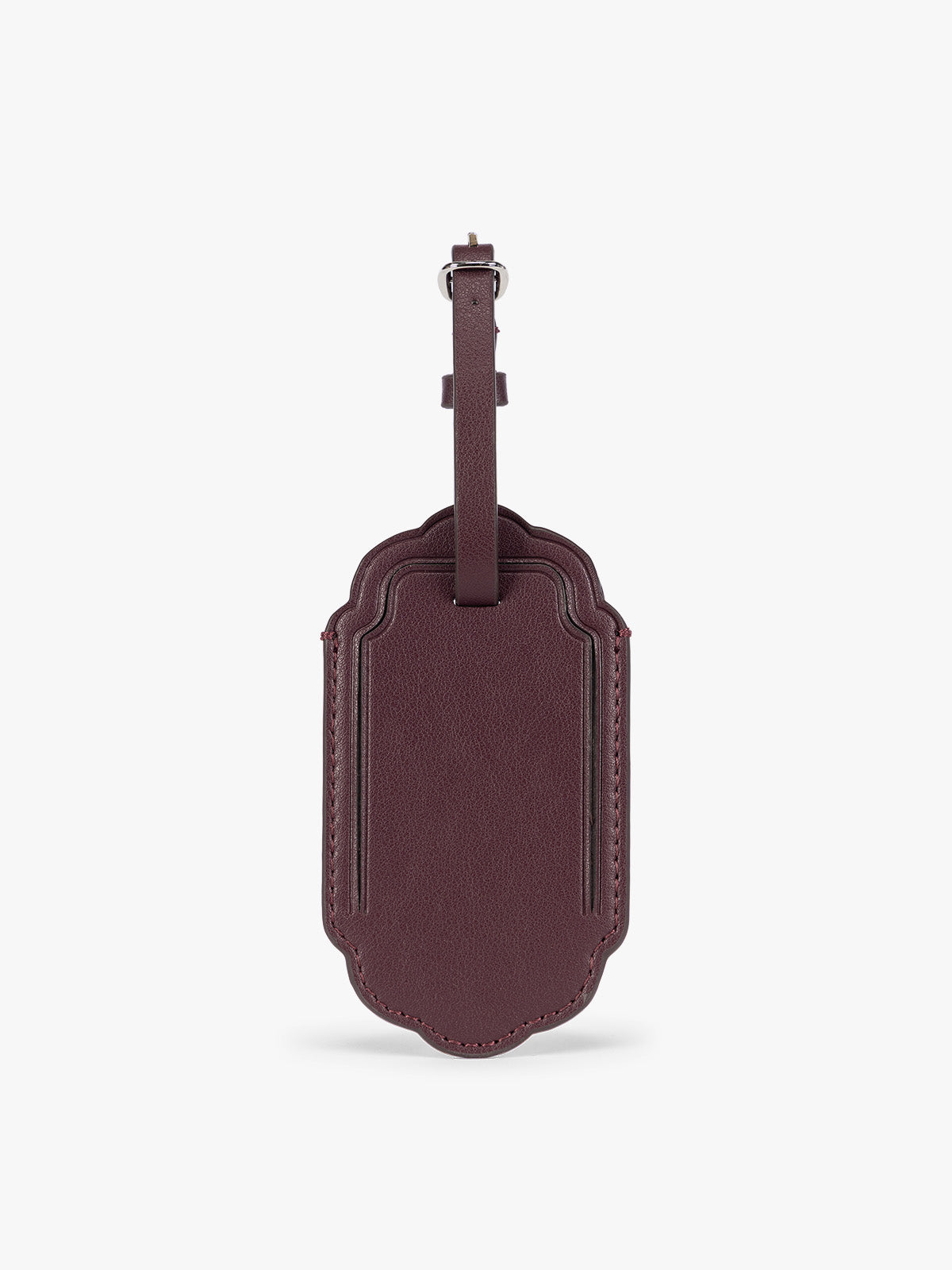 A dark red CALPAK Vault luggage tag with a scalloped border and a matching honey dark red , shown against a plain white background; ATV2601-DARK-CHERRY