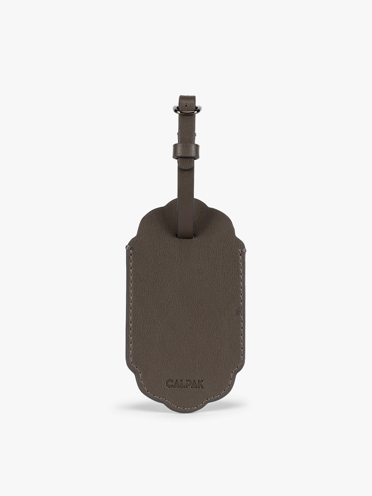 Backside of a dark brown CALPAK Vault luggage tag with a scalloped border and a matching dark brown strap, shown against a plain white background; ATV2601-MUSHROOM