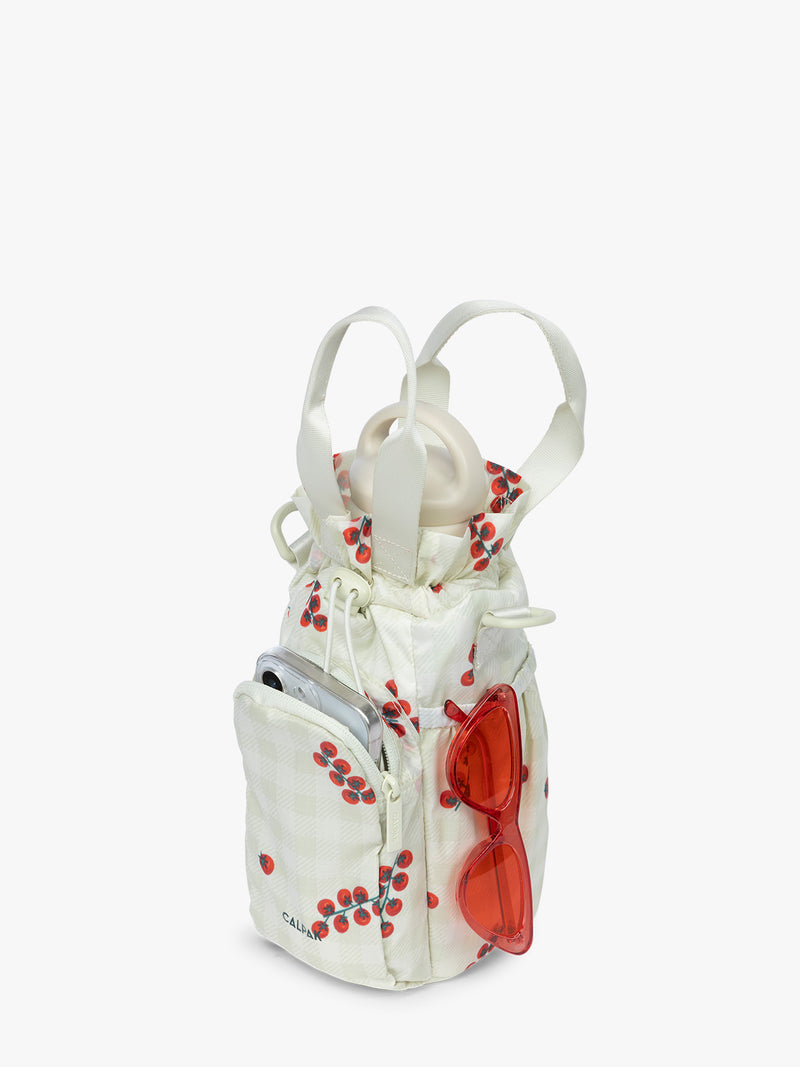 Water bottle and items in the CALPAK Water Bottle Holder in light green Celadon and white gingham with tomato print