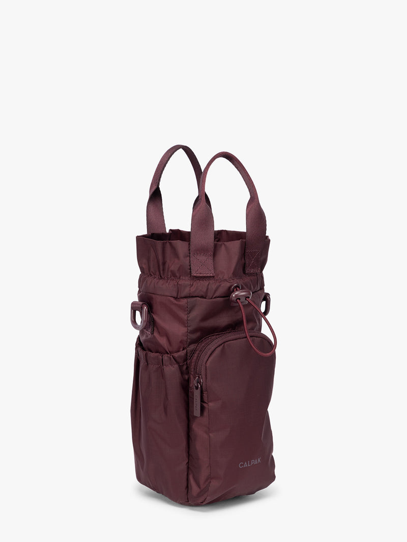 Burgundy Dark Cherry CALPAK Water Bottle Holder with top handles, drawstring top, front zippered pocket, and a detachable shoulder strap that is expandable