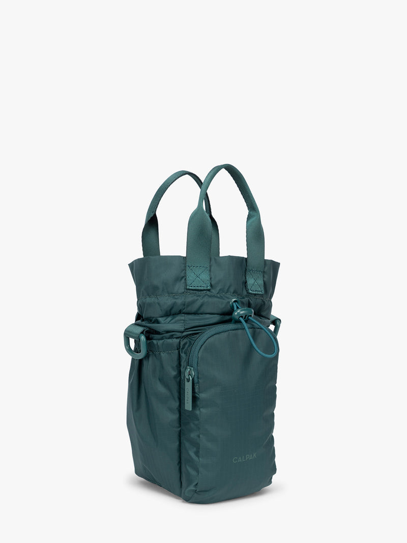 Dark green teal Kale CALPAK Water Bottle Holder with top handles, drawstring top, front zippered pocket, and a detachable shoulder strap with expandable top