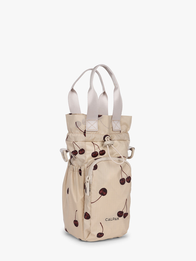 Opened view CALPAK Water Bottle Holder in Oatmeal Chery in beige with cherry pattern