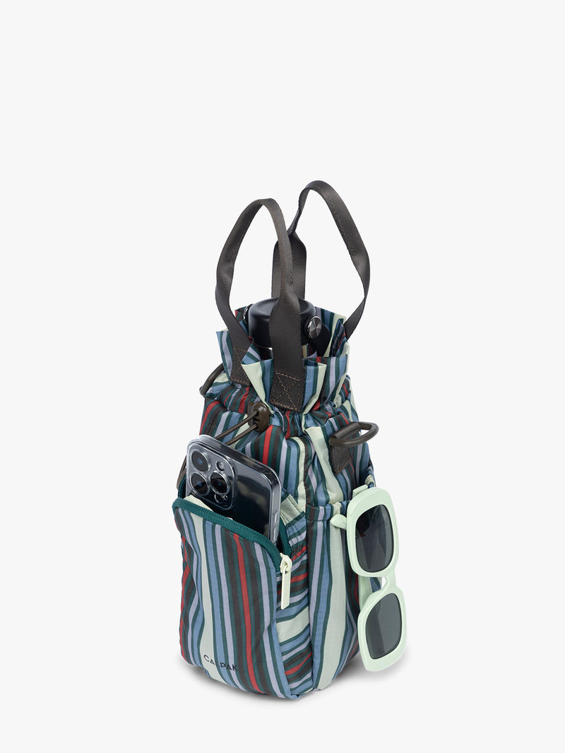 Items and water bottle in the CALPAK Water Bottle Holder in multicolor stripe Riviera Stripe