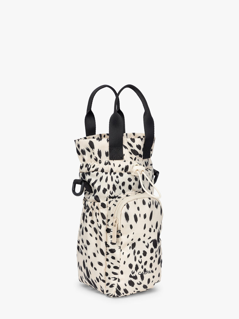 White and black animal print Snow Leopard CALPAK Water Bottle Holder with top handles, drawstring top, front zippered pocket, and a detachable shoulder strap that is expandable