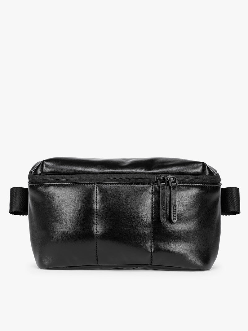 Black vegan leather CALPAK Luka Belt Bag with a zippered front pocket and side straps, shown against a plain white background