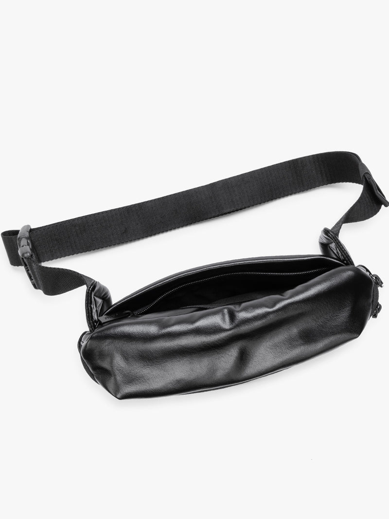 Top view of back zippered pocket of a black vegan leather CALPAK Luka Belt Bag with a zippered front pocket and side straps, shown against a plain white background