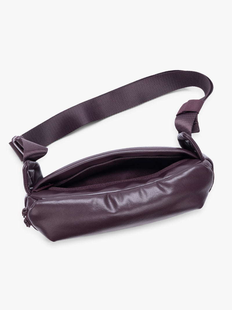 Top view with back zipper pocket of a deep burgundy Dark Cherry vegan leather CALPAK Luka Belt Bag with a zippered front pocket and side straps, shown against a plain white background