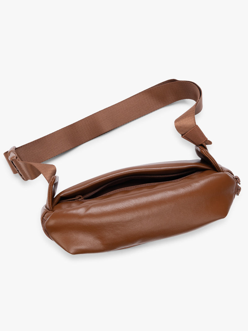 Top view of back zipper pouch of a light Honey Brown Mushroom vegan leather CALPAK Luka Belt Bag with a zippered front pocket and side straps, shown against a plain white background