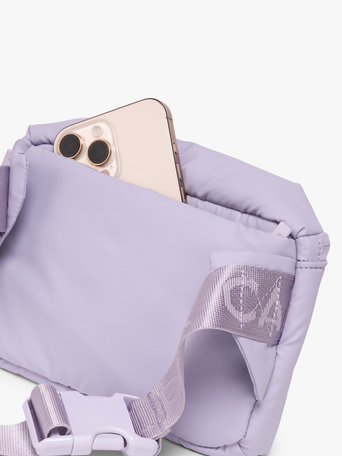 Phone in back pocket of CALPAK Luka Mini Belt Bag in light purple Orchid on white background; BBM2201-ORCHID