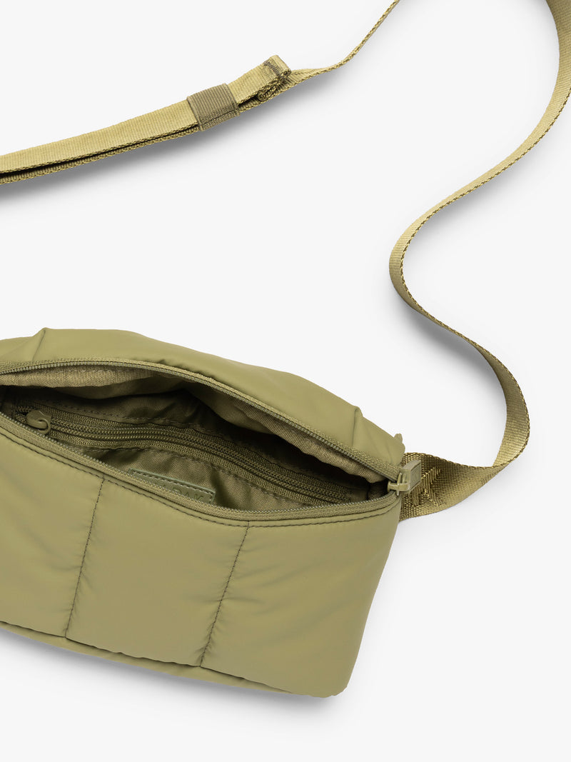 Opened and strap of CALPAK Luka Mini Belt Bag in dark green Pistachio on white background