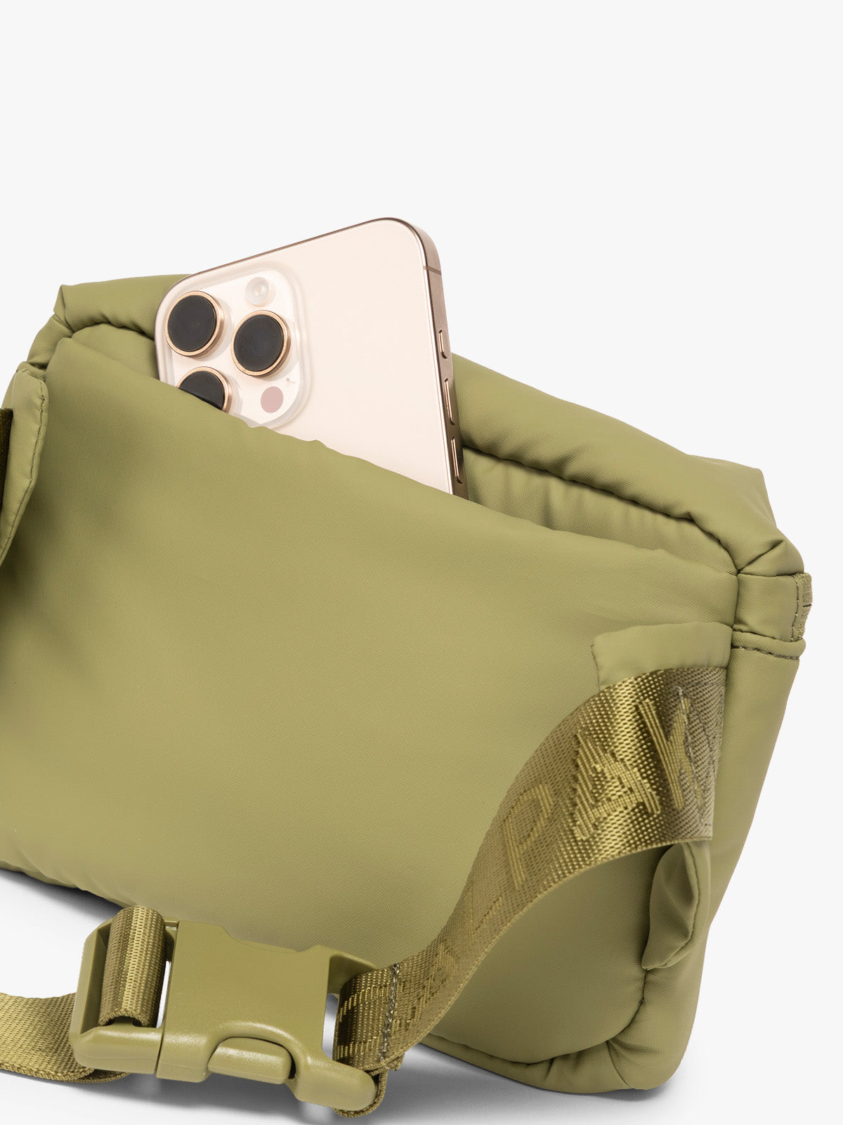 Phone in back pocket of CALPAK Luka Mini Belt Bag in dark green Pistachio on white background; BBM2201-PISTACHIO