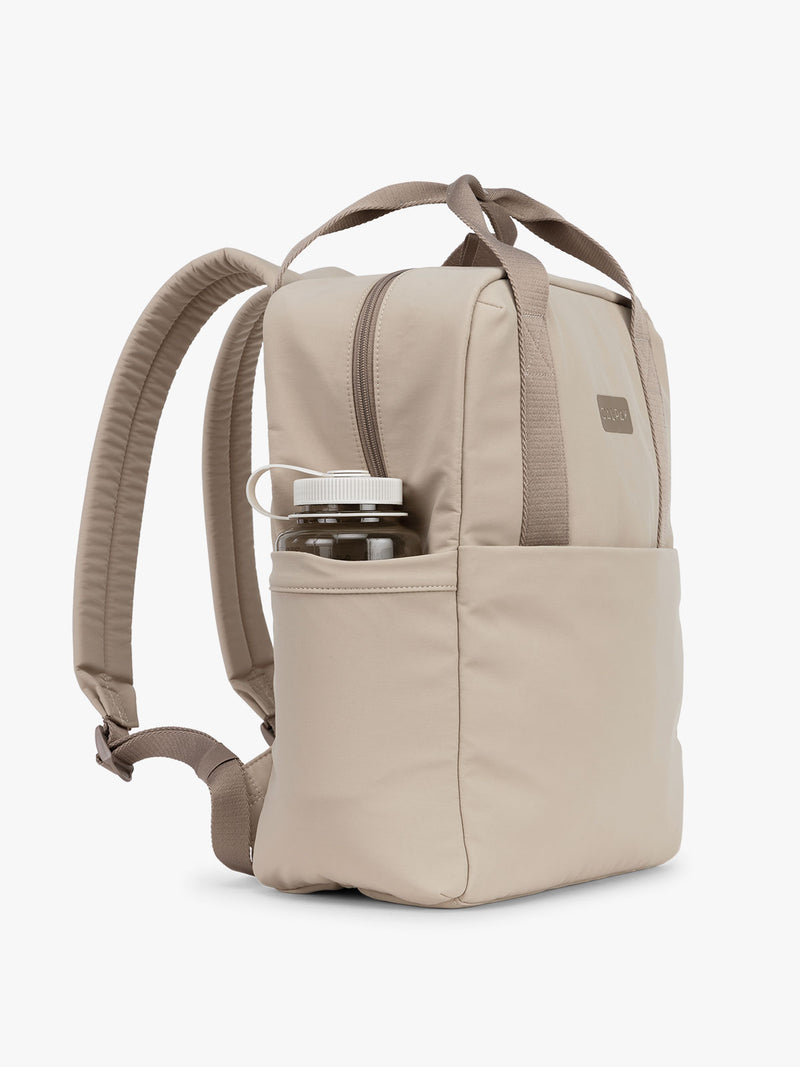 CALPAK Connect Laptop Backpack in grey beige Greige side view with a white background