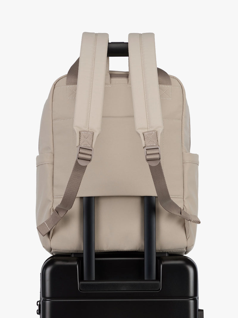 CALPAK Connect Laptop Backpack in grey beige Greige with luggage trolley sleeve on a white background