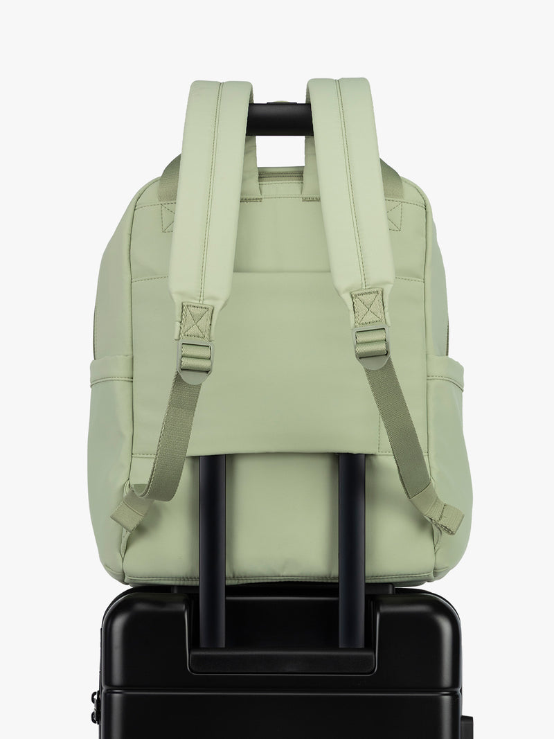CALPAK Connect Laptop Backpack in light green Meadow with luggage trolley sleeve on a white background