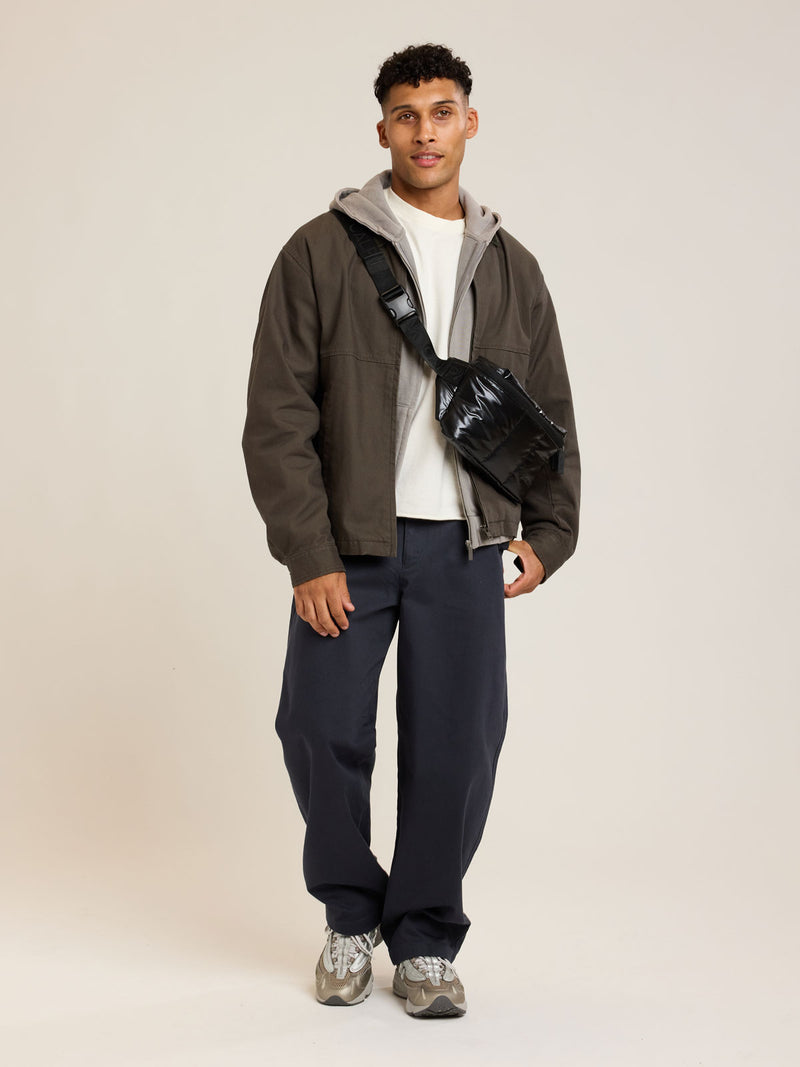 Model wearing CALPAK Luka Belt Bag in Glazed Black