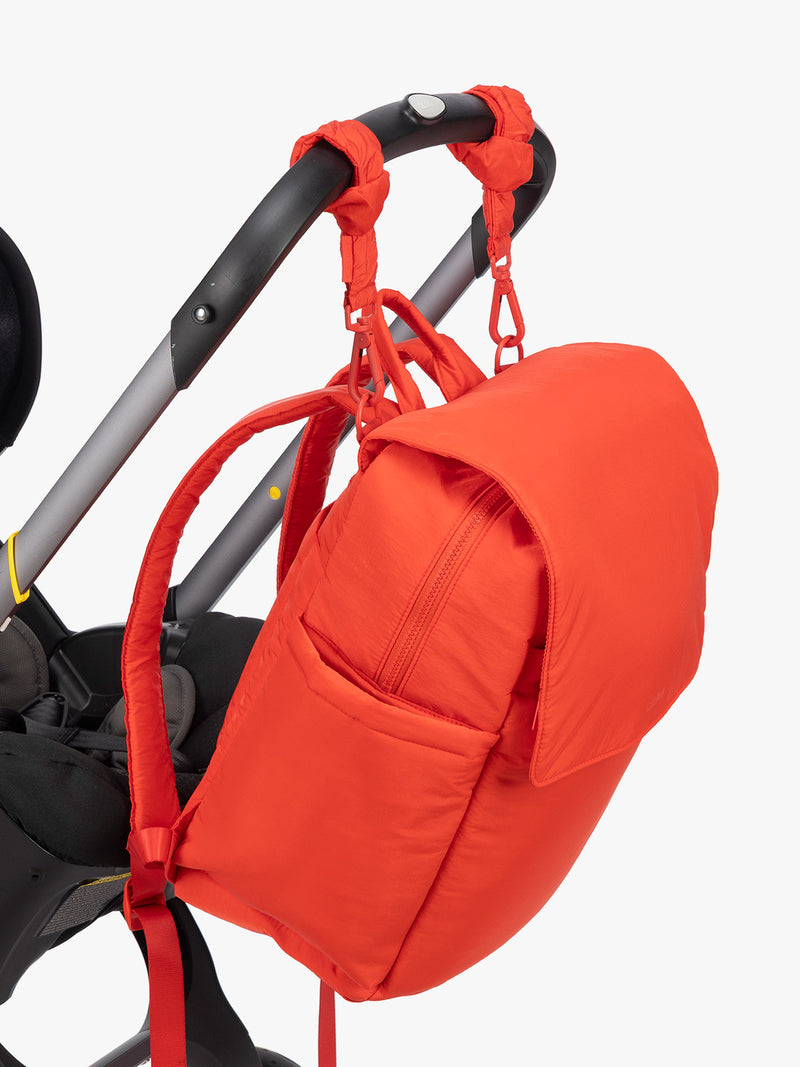 CALPAK Diaper Backpack in red Tomato strapped on stroller