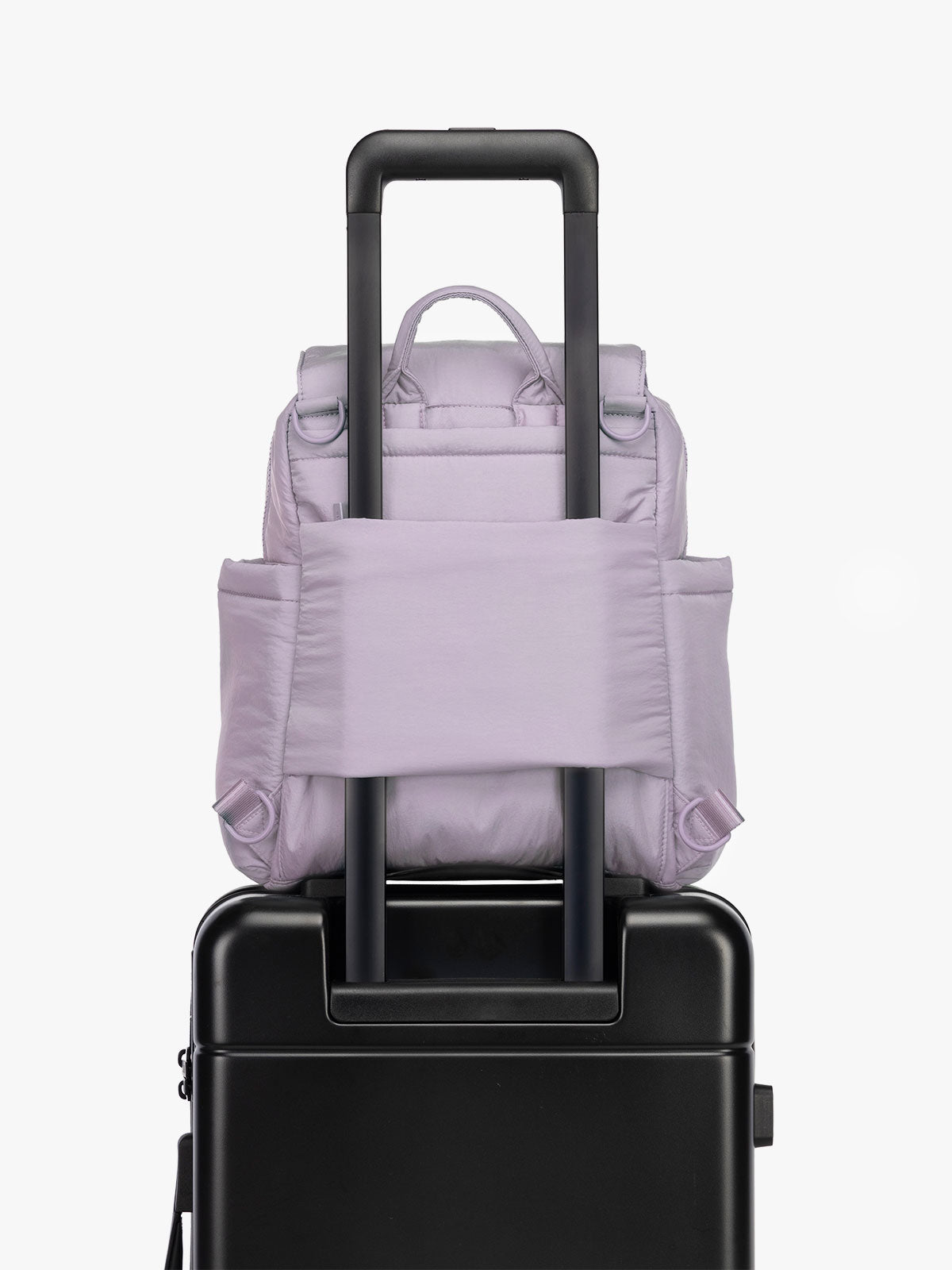 CALPAK Convertible Mini Diaper Backpack in lavender purple on luggage with trolley sleeve; BPC2401-ORCHID