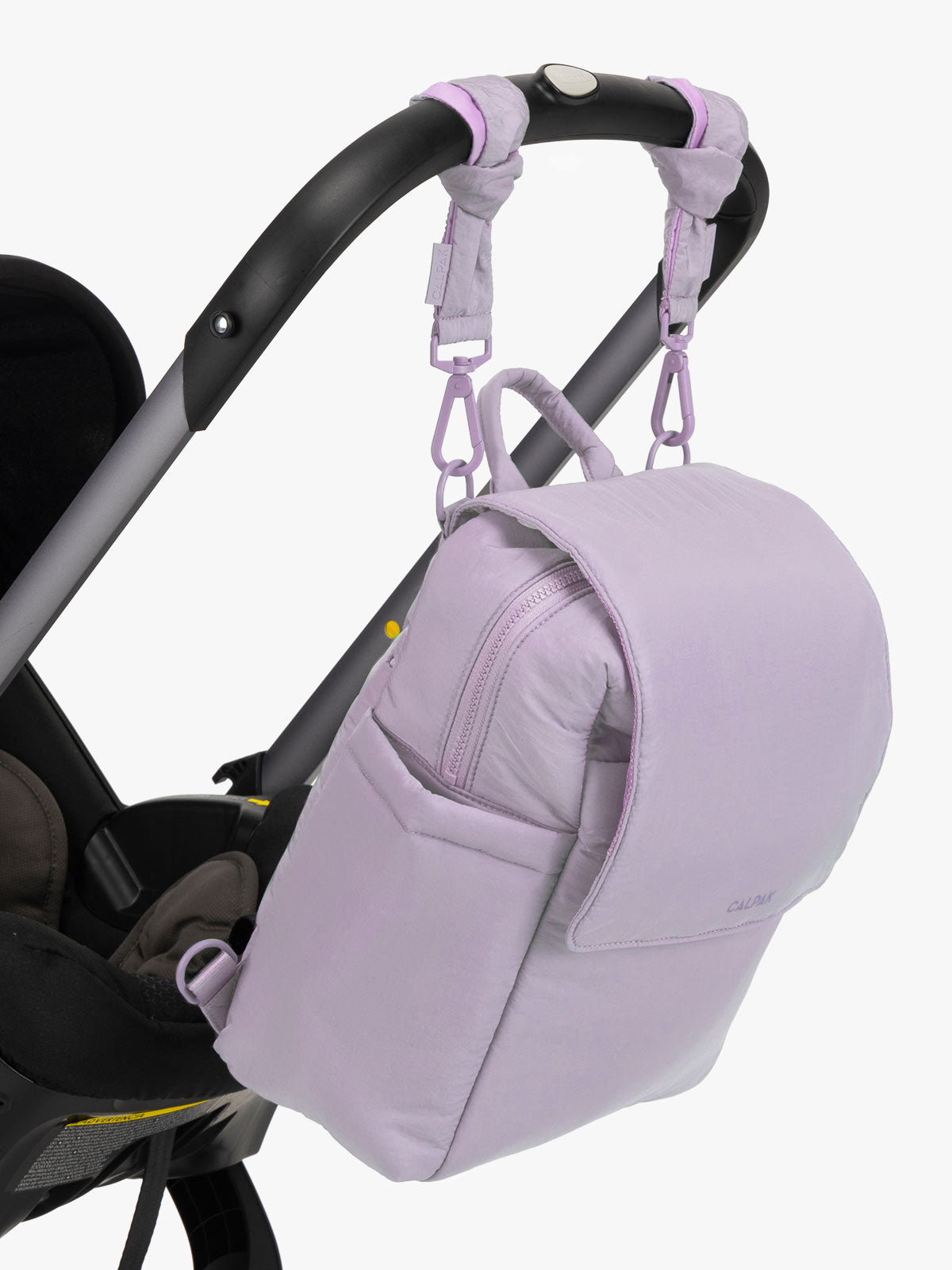 CALPAK Convertible Mini Diaper Backpack in lavender purple hanging on stroller with stroller straps; BPC2401-ORCHID