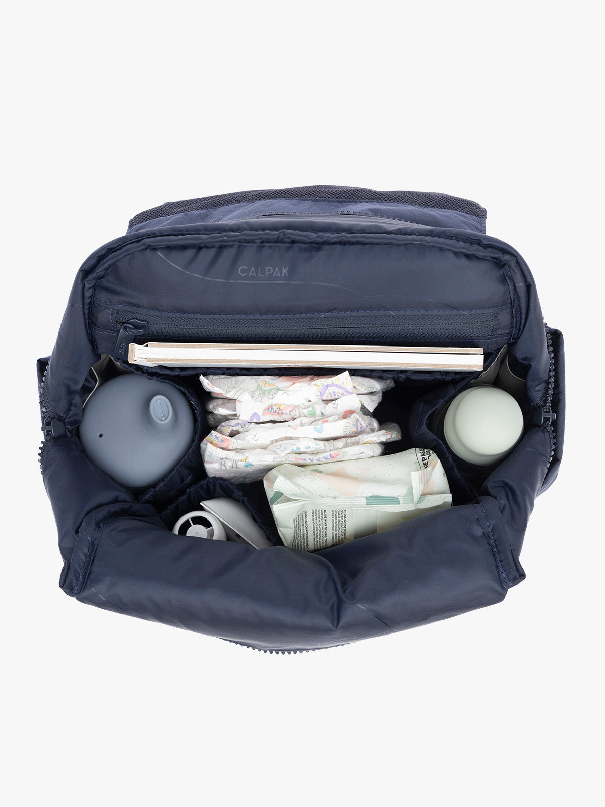 Baby items inside CALPAK Mini Diaper Backpack in blue Navy; BPC2402-NAVY