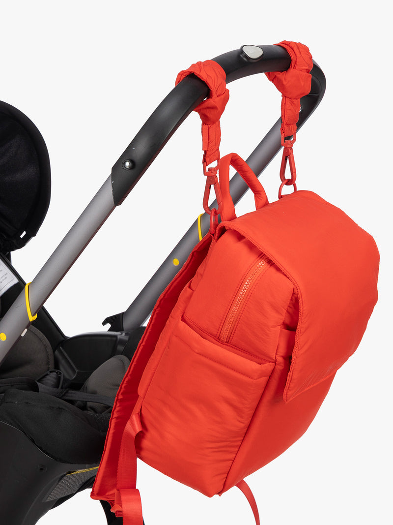 CALPAK Mini Diaper Backpack in red Tomato on stroller with stroller strap