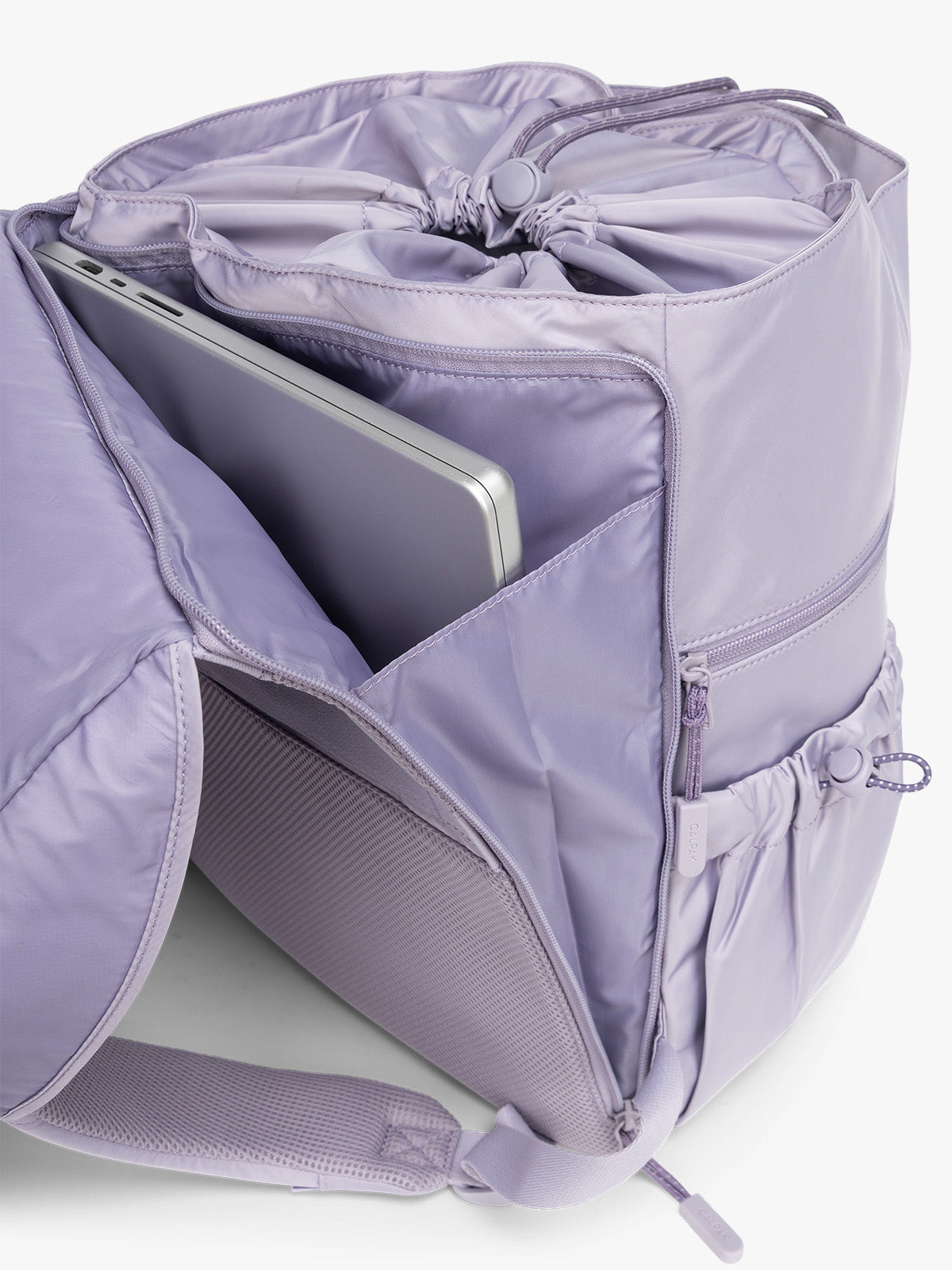 Close-up of a gray drawstring bag with a button closure of CALPAK Fit Gym Backpack in light purple Iris with white background; BPF2601-IRIS