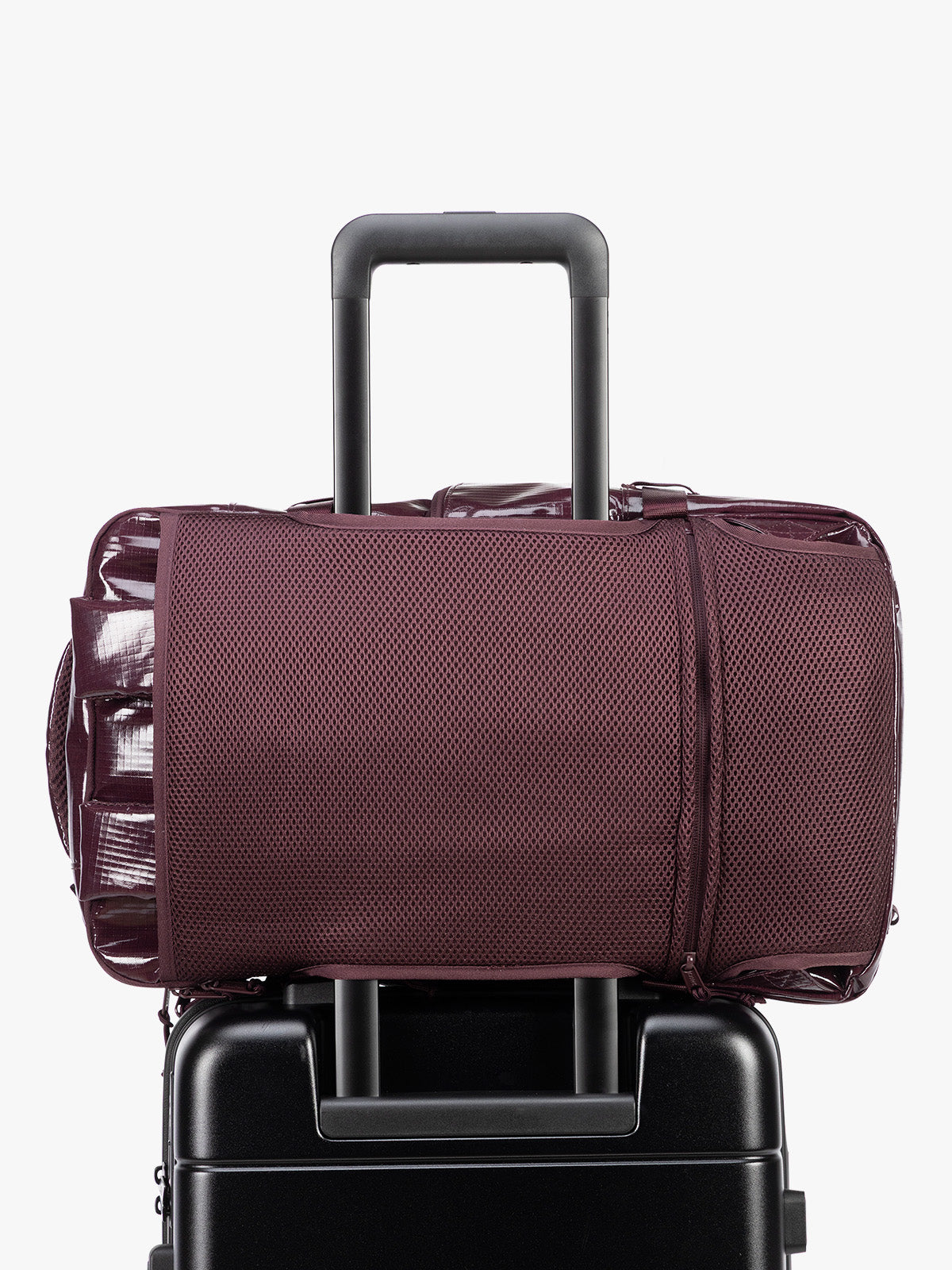 Backside Trolley sleeve of CALPAK Terra 26L Laptop Backpack in dark red Dark Cherry with multiple pockets on a white background; BPH2201-DARK-CHERRY