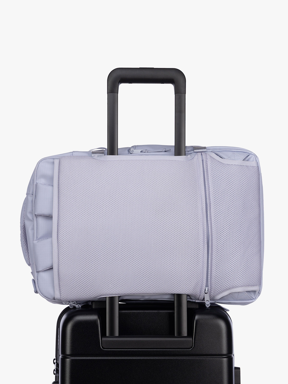 Luggage trolley sleeve of CALPAK Terra 26L Laptop Duffel Backpack with multiple pockets in light purple Sea Glass on a white background; BPH2201-SEA-GLASS