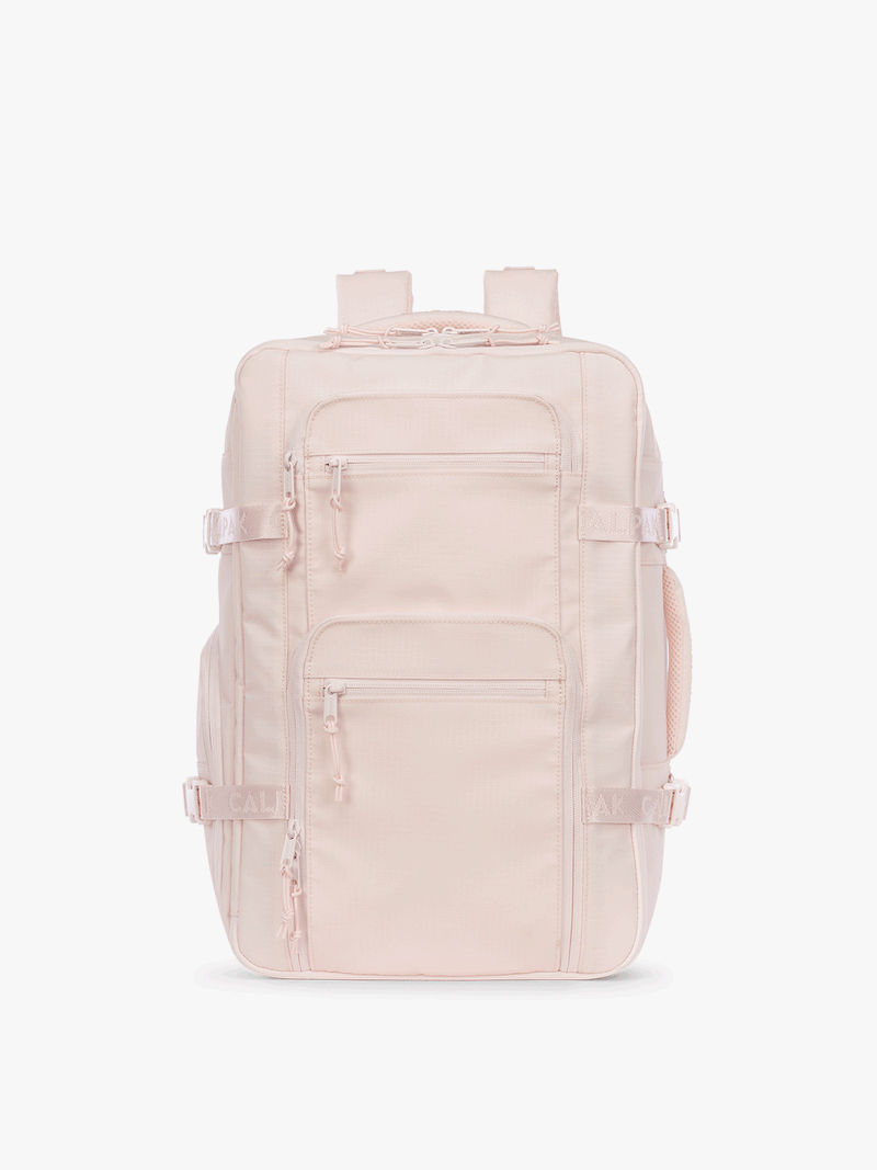 GIf that shows the front, back and sides of the CALPAK Terra 26L Laptop Duffel Backpack with multiple pockets in light pink Shell Pink on a white background