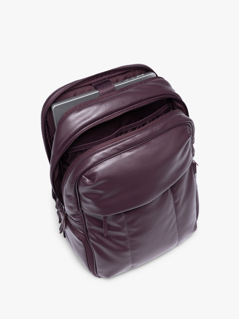 Laptop sleeve of CALPAK Dark Cherry Luka 15 inch Laptop Backpack in vegan leather with a glossy finish, featuring a top carry handle, a main zippered compartment, and a front slip pocket, shown against a plain white background
