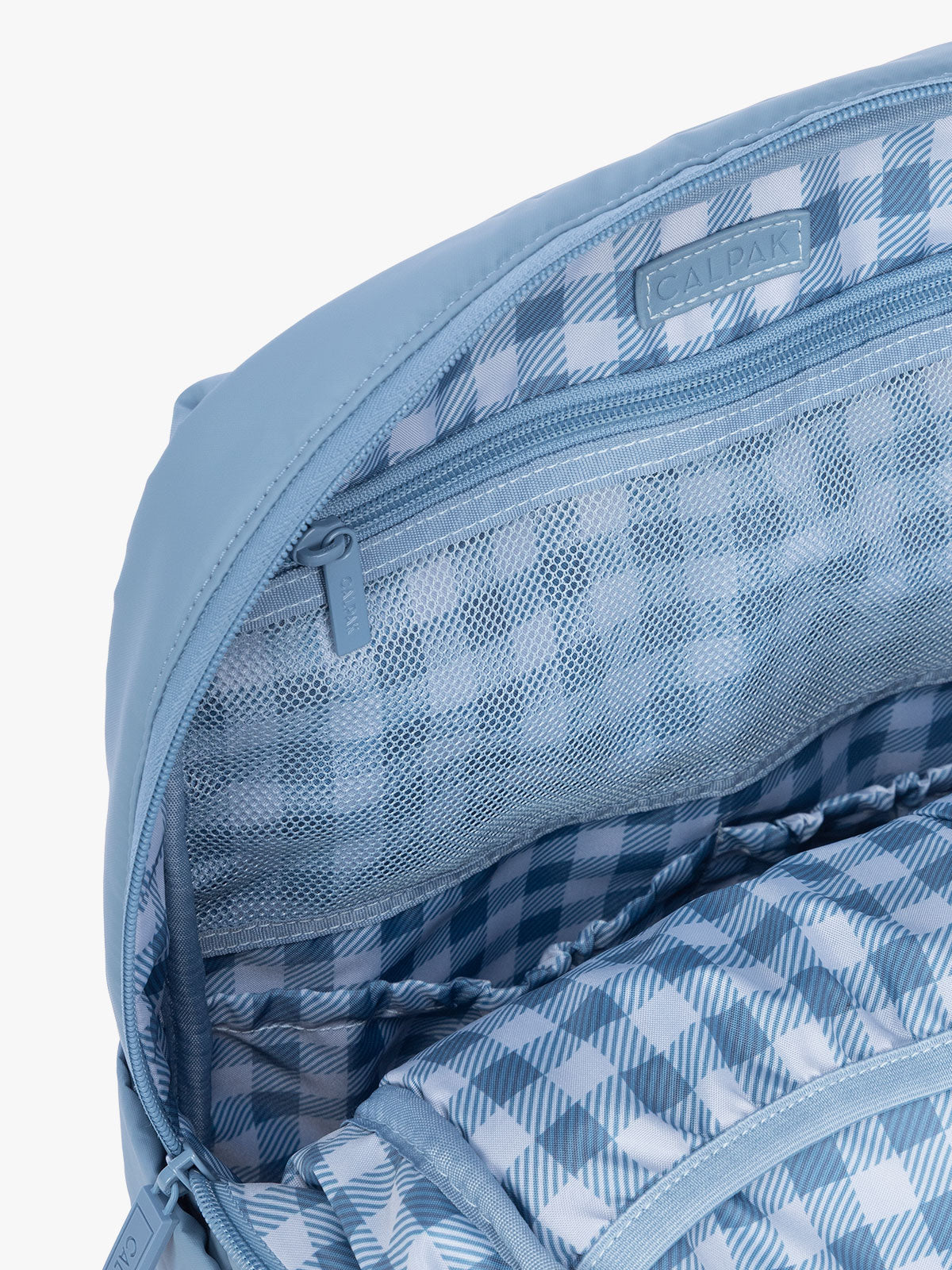 Close-up of inside zipper of CALPAK Luka 15" Backpack in light blue French Blue; BPL2001-FRENCH-BLUE