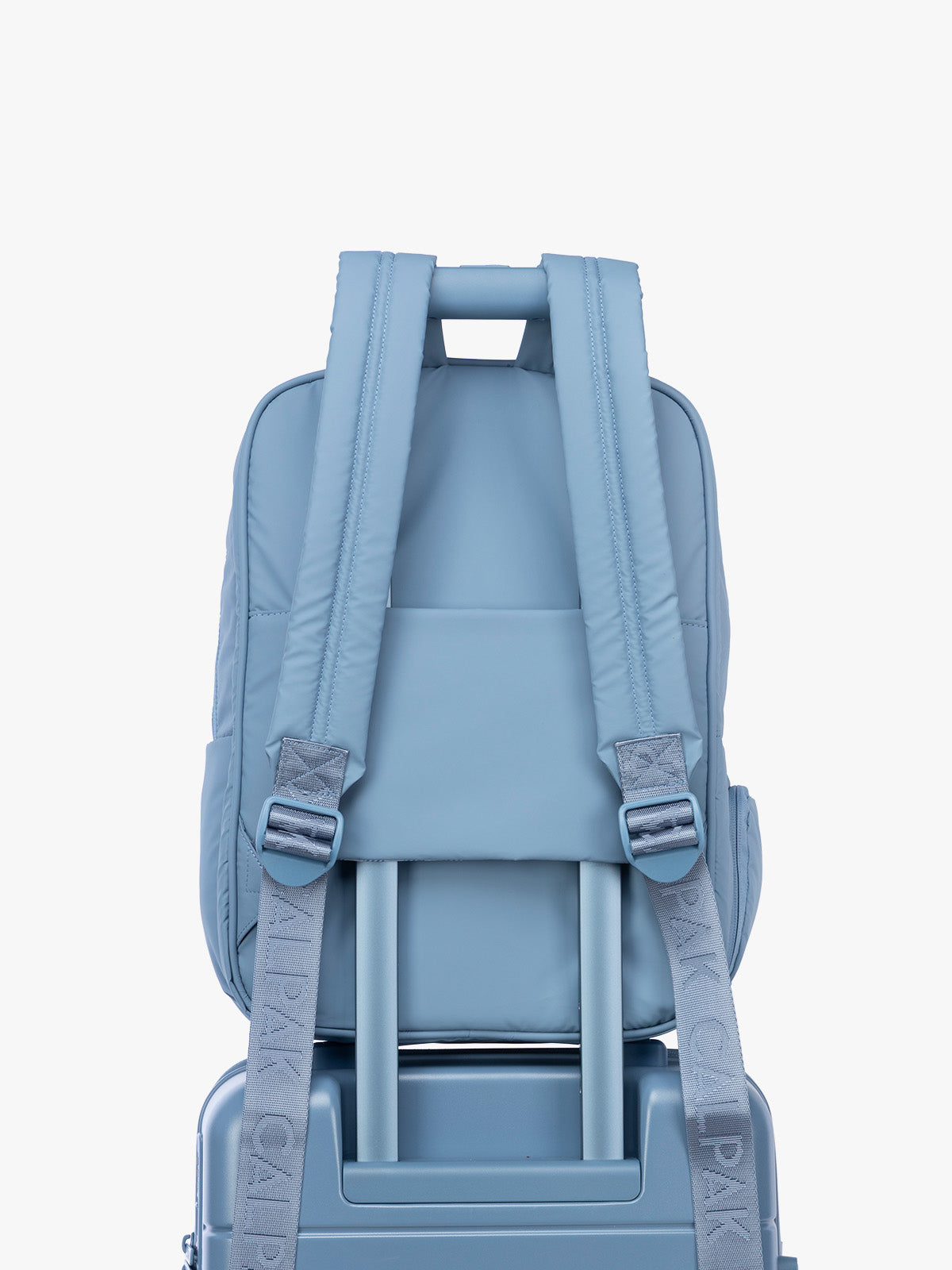 Luggage trolley sleeve of the CALPAK Luka 15" Backpack in light blue French Blue; BPL2001-FRENCH-BLUE