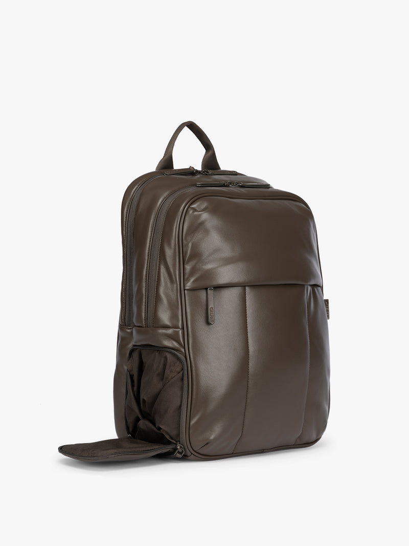 Side shoe compartment of CALPAK Mushroom brown Luka 15 inch Laptop Backpack in vegan leather with a glossy finish, featuring a top carry handle, a main zippered compartment, and a front slip pocket, shown against a plain white background